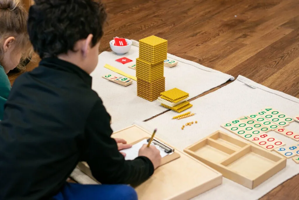 This work allows our children to add large numbers together. Here two children 'build' the number '3,728'.'